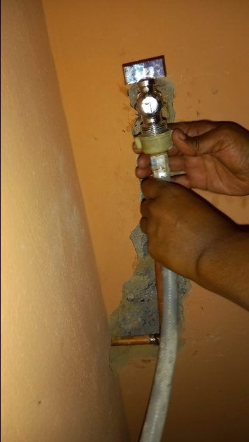 Hands installing a plumbing fixture during a pipe repair by Sphapower Plumbing